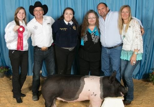 Friendly Li’l Spenders members pose with an FFA student and one of the animals the group purchased at the 2020 Katy ISD FFA Livestock Show. The group works to ensure all FFA students are supported by the community and to allow even those who can only contribute a small amount of money to the program to be able to participate through crowd funding.